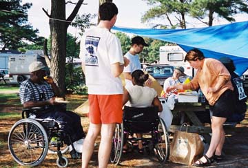 group with wheelchair at campsite